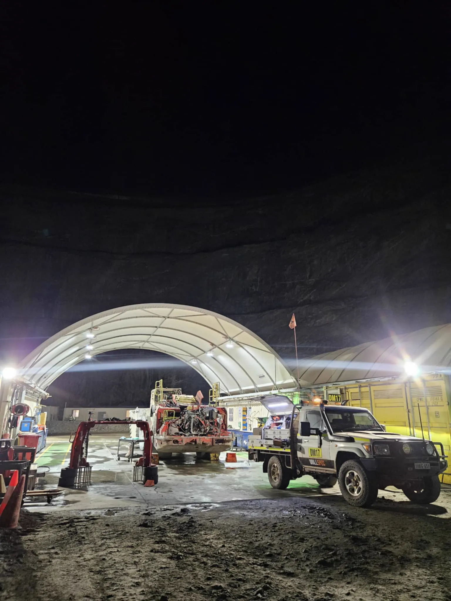 Drillspec DM17 service ute at a night-shift workshop dome with a drill rig in for repair