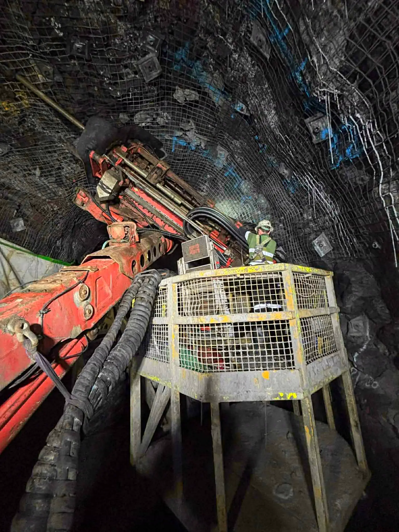 Underground jumbo drill rig at the face in a hard-rock decline